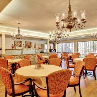 Elegant dining area with chandeliers and comfortable seating.