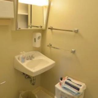 A small, neatly organized bathroom with a sink and mirror.
