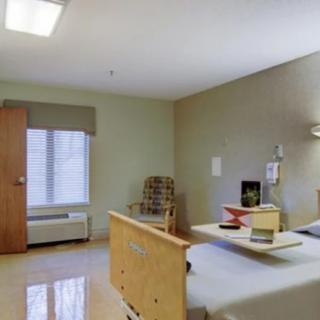 A hospital room with a bed and medical equipment.