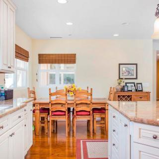 A cozy kitchen and dining area featuring wooden furniture and bright natural lighting.