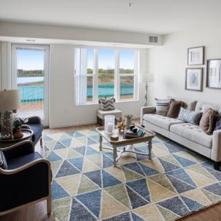 A modern living room with stylish furniture and a scenic view through the windows.