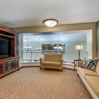 A cozy living room with comfortable seating and a large TV.