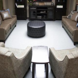 A modern living room with symmetrical arrangement of sofas and chairs around a central coffee table.