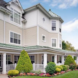 A charming multi-story house with a well-maintained garden.