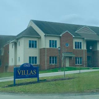 A residential building showcasing the 'Villas' sign, indicating apartments for rent or lease.