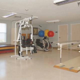 A rehabilitation gym equipped with exercise machines and therapy tools.