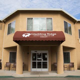 The entrance of an assisted living facility with a maroon awning.