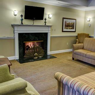A cozy living room with comfortable seating and a fireplace.