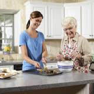 Two women enjoy baking together in the kitchen.