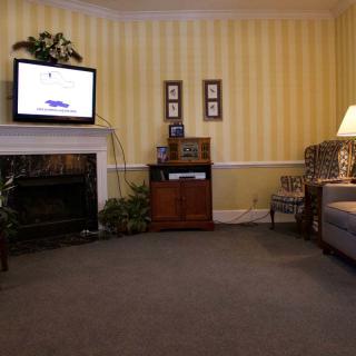 A cozy living room with a fireplace, television, and comfortable seating.