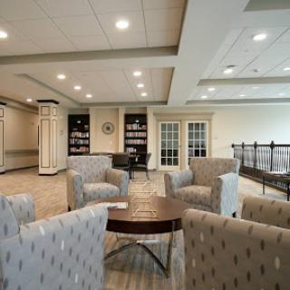 A contemporary lounge area with comfortable seating and warm lighting.