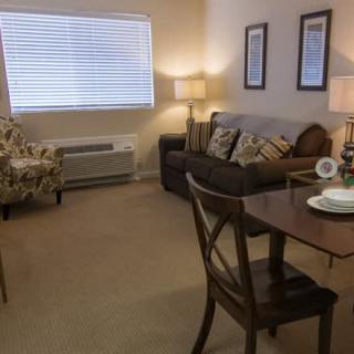 A cozy living room with comfortable seating and warm lighting.