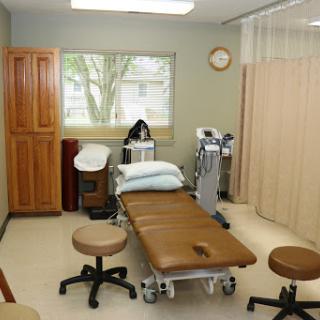 A clean and organized medical examination room equipped for patient care.
