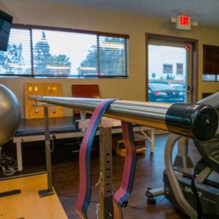 A rehabilitation room with exercise equipment and balance tools.