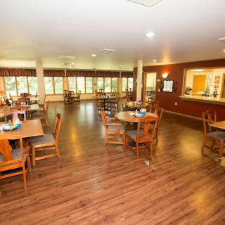 Spacious dining area with wooden floors and ample lighting.