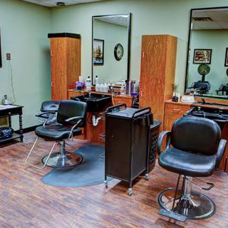 An interior view of a hair salon with chairs, mirrors, and styling stations.