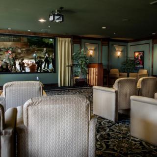 Cozy theater room with comfortable seating and a projector.