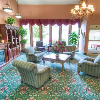 A cozy living room with a classic-style sofa set and chandelier.