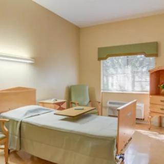A simple and clean hospital room with basic amenities.