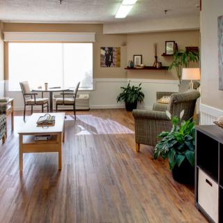 A cozy living room with comfortable seating, wooden flooring, and natural light.