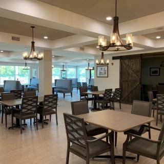 A spacious dining area with elegant chandeliers and ample natural lighting.