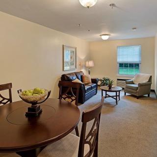 A cozy living and dining area with warm lighting and comfortable furniture.