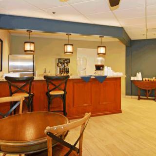 A cozy bar area with wooden furniture and warm lighting.