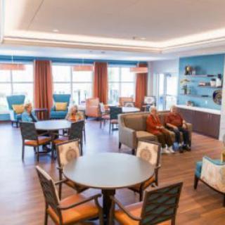 A spacious lounge with comfortable seating and large windows allowing natural light.