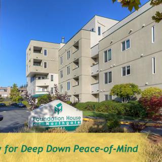 Exterior view of an apartment complex with well-maintained landscaping.