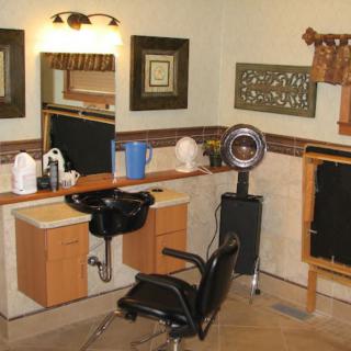 An interior view of a hairdressing salon with styling chairs and mirrors.