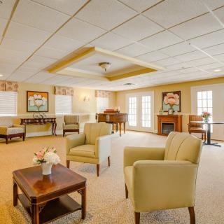A spacious living room with comfortable chairs and elegant decor.