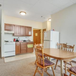 Cozy apartment kitchen and dining area with wooden furniture.