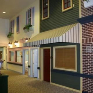 An indoor space designed to mimic a street with storefronts and decorative elements.