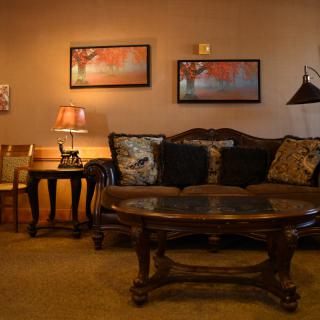 A cozy living room with a sofa, coffee table, and ambient lighting.