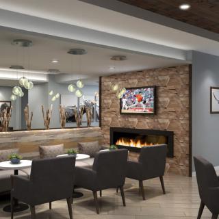 A modern lounge with a cozy fireplace and comfortable seating arrangement.