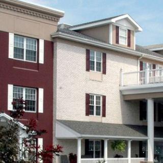 A multi-story residential building with red and beige exterior walls.