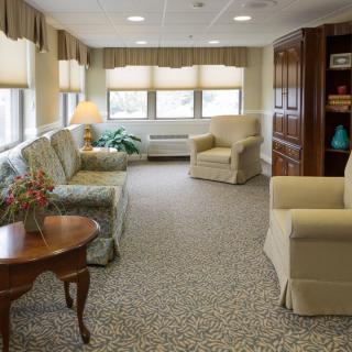 A cozy living room with comfortable seating and natural light from large windows.