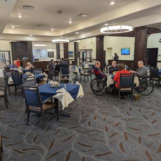 A bustling dining area with several patrons enjoying their meals in a comfortable setting.