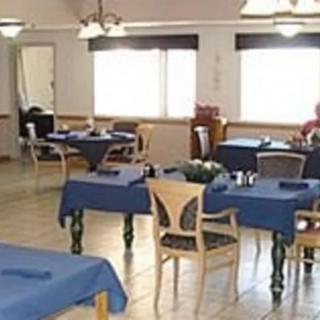 A spacious dining area with several tables and chairs arranged neatly.
