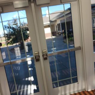 A view of double glass doors leading to a courtyard.