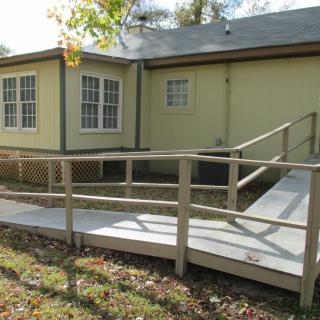 A house exterior with an accessible ramp leading to the entrance.