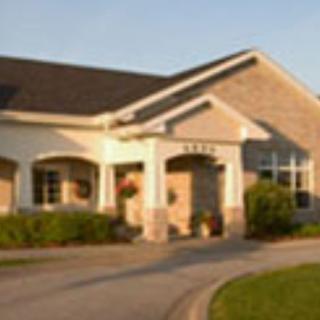 A suburban residential house with a landscaped driveway.