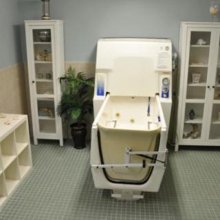A serene therapy room featuring a modern hydrotherapy bathtub.
