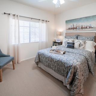A cozy and elegantly styled modern bedroom with a calming color palette and natural light.