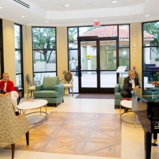 A spacious lobby with comfortable seating and large windows.