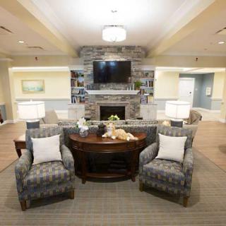 A cozy living room with a fireplace, television, and comfortable seating.