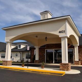 The front entrance of a building with a covered driveway.