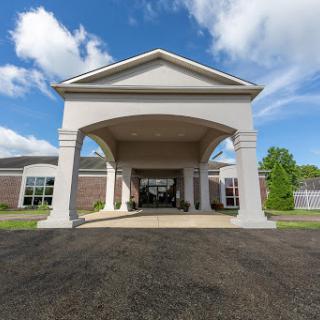 A welcoming entrance of a building under a bright sky.