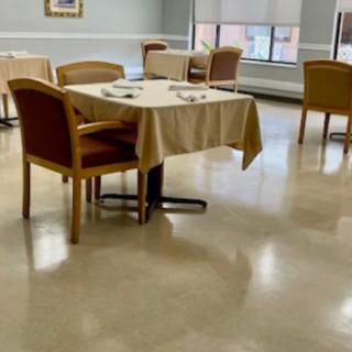 An empty dining room with neatly arranged tables and chairs.