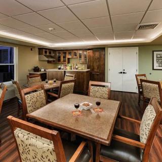 A cozy dining area with a table and chairs, adjacent to a small kitchenette.